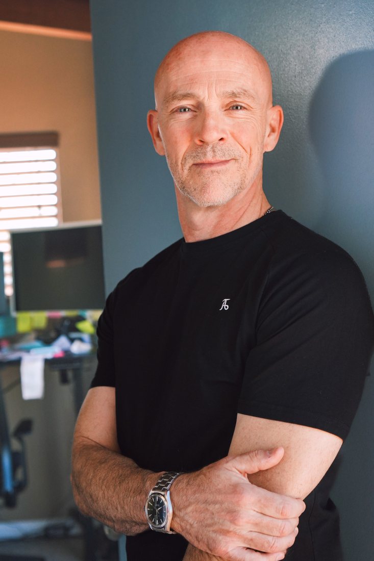 Steve Cleland, arms folded, standing in his office